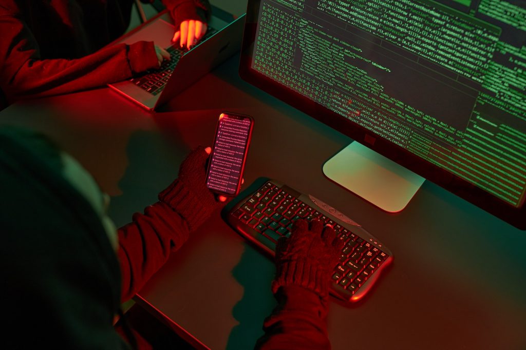 Anonymous people using computer and coding to break into system. Cyber attack. Cyber war. Hackers